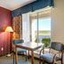 Red Roof Inn Vincennes guest room with table and chairs beside a sliding glass door to a river view