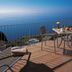 Village Cabo Girao in Câmara de Lobos with sea-view terrace, lounge chairs and table overlooking the ocean