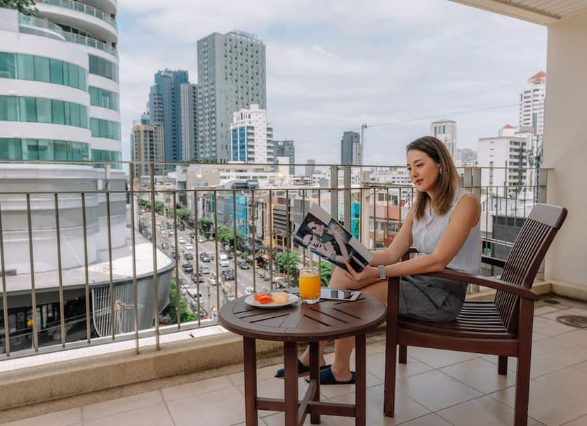 Centre Point Sukhumvit Thong-Lo in Bangkok balcony with city skyline and seated guest