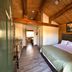 Zion Ponderosa Ranch Resort room with log walls, vaulted wood ceiling, and king bed in Mount Carmel