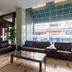Beifang Langyue Hotel (Beijing Ganjiakou) lobby seating area with leather sofas and large street-facing windows