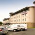 Premier Inn Newcastle Airport in Newcastle upon Tyne exterior with parking lot and guest vehicles