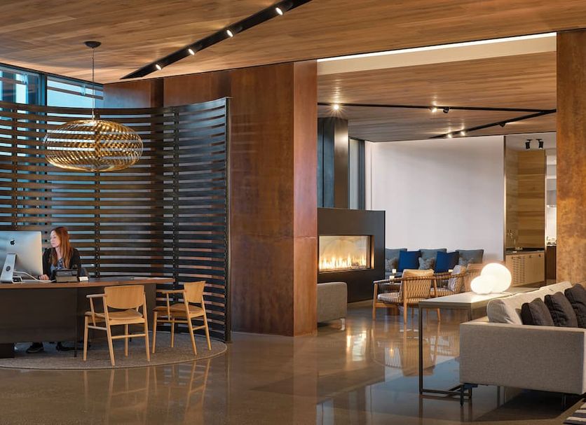 Hotel San Luis Obispo lobby with front desk, lounge seating and fireplace in San Luis Obispo