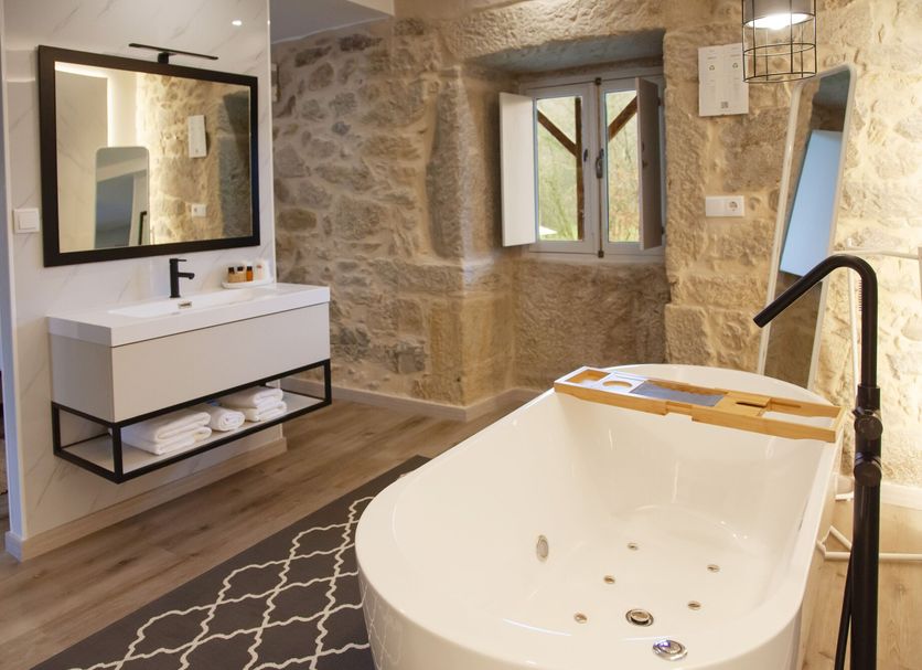 Quinta Do Caminho, Valença: stone bathroom with freestanding tub, walk-in shower and vanity