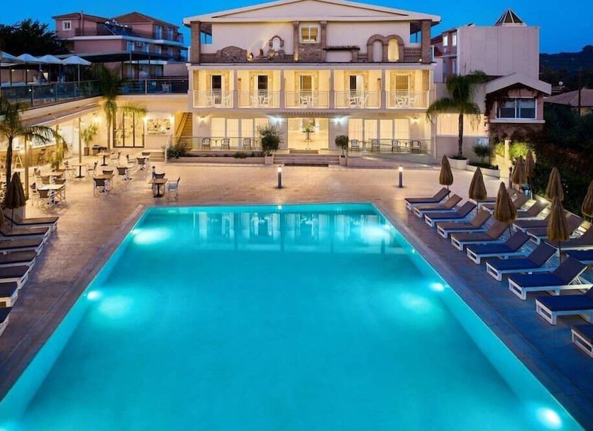 Mavrikos Hotel in Tsilivi with illuminated outdoor pool and sun loungers at dusk