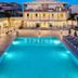 Mavrikos Hotel in Tsilivi with illuminated outdoor pool and sun loungers at dusk