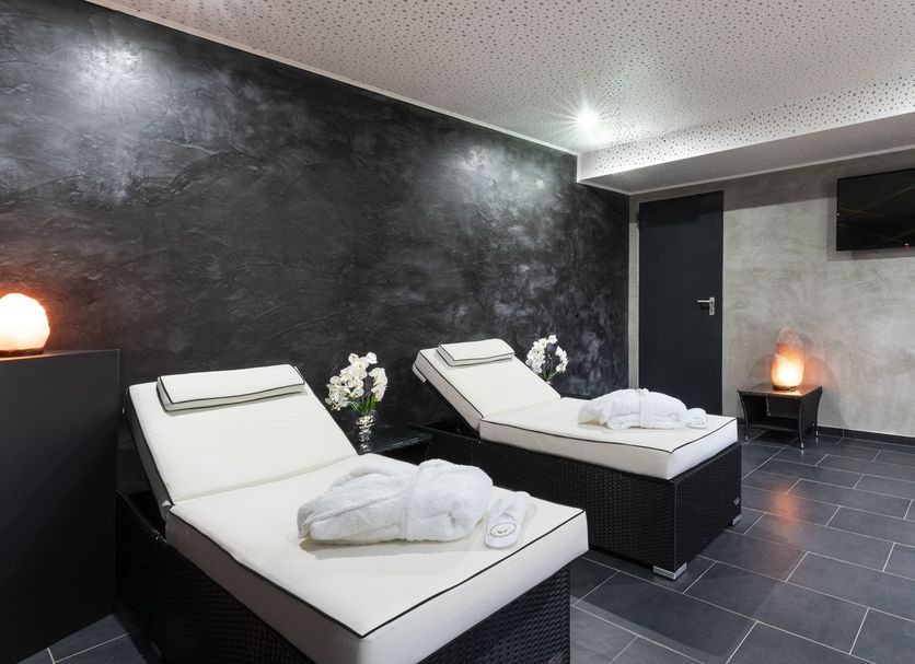PLAZA Premium Parkhotel Norderstedt spa relaxation room with two loungers and ambient lighting