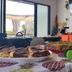 Breakfast buffet at Coqui del Mar Guesthouse in San Juan with dishes on a table beside an open patio door