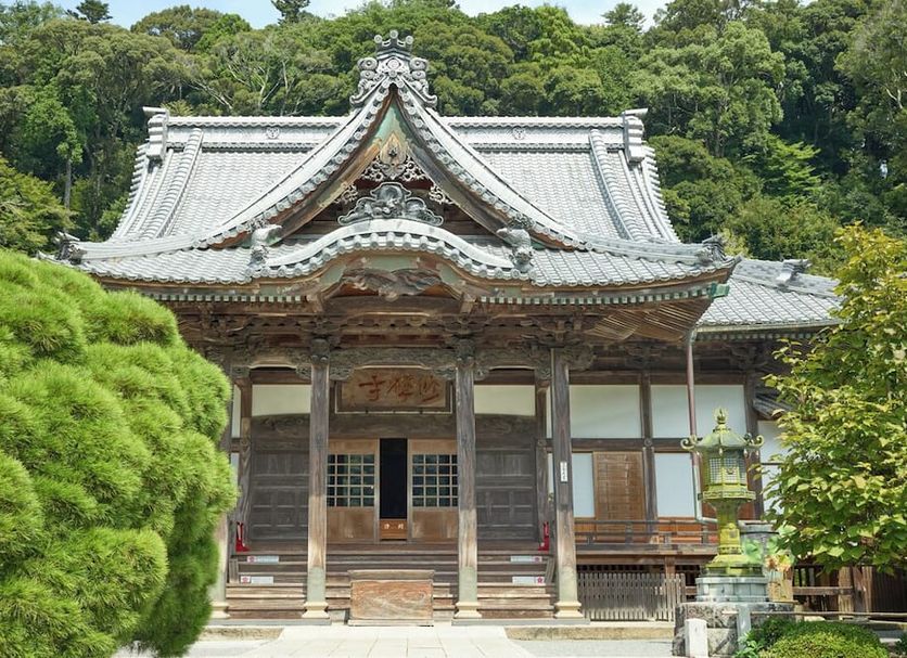 AMMS Hotels Shuzanji Onsen Hotel TAKITEI in Izu, traditional Japanese temple-style building amid lush greenery