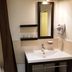 Auberge de la Baie in Pontorson bathroom with sink, mirror, shelves and shower curtain