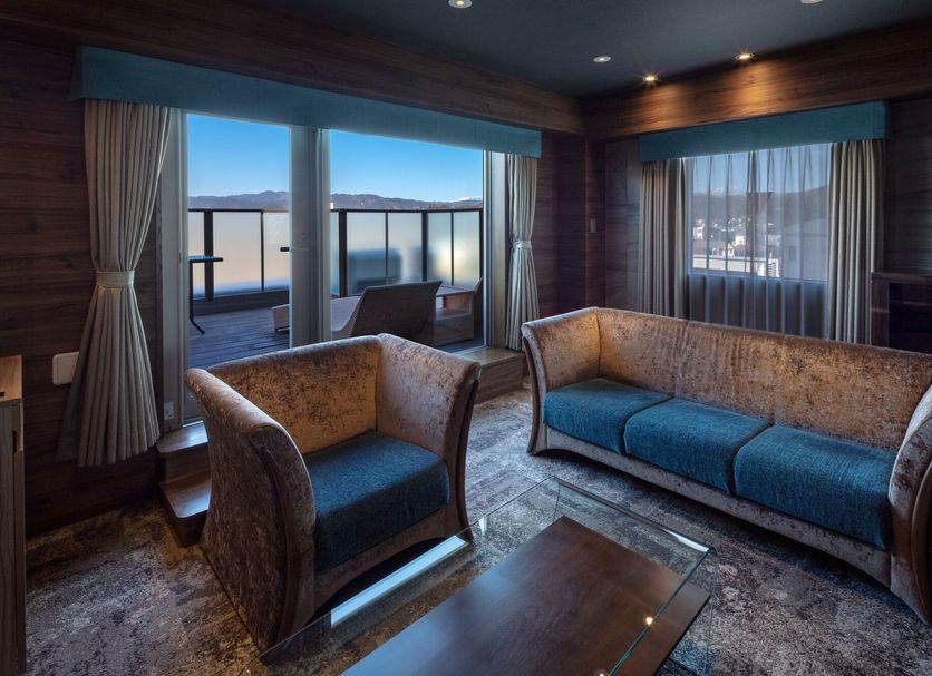 Wat Hotel & Spa Hida Takayama lounge with lake view through sliding glass doors in Takayama