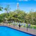 Surfers Plaza Resort in Surfers Paradise pool area with lounge chairs and skyline view