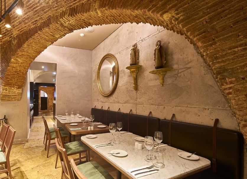 My Story Hotel Tejo Lisbon dining room with arched brick ceiling and long banquet table