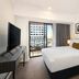 The York by Swiss-Belhotel in Sydney guest room with balcony, city view, TV, and king bed