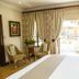 Ivory Manor Boutique Hotel, Pretoria room with balcony doors, chairs and garden view