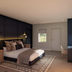 The Clements Hotel Cambridge guest room with king bed, patterned rug and lounge chair