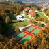 Gazelle Resort & Spa in Karacasu, aerial view of tennis courts, resort buildings and wooded hills