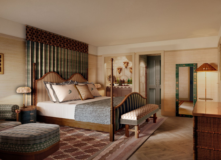Faraway Sag Harbor guest room with canopy bed, bench, wicker chair and patterned rug in Sag Harbor