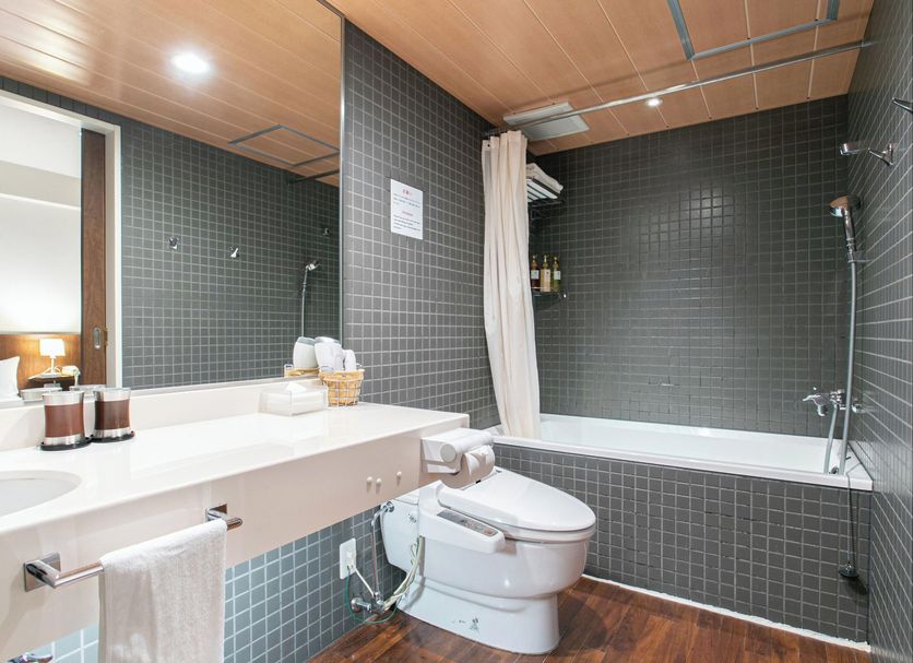 Sutton Hotel Hakata City bathroom in Fukuoka with bathtub, shower, and toilet