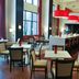 Hampton Inn & Suites Shreveport/South breakfast lounge with tables, chairs and red pendant lights