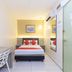 Hotel Suria Malaqa room in Malacca with bed, desk, wall mirror and air-conditioning
