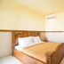 Tanjung Alam Hotel in Buleleng guest room with wooden bed and wardrobe