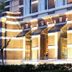 Boutique Hotels Manna & Blue in Nijmegen, brick hotel entrance with lit awning and arched windows