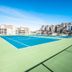 Barrier Island Station in Duck with a tennis court beside resort buildings under a bright blue sky