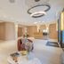 Yuna Porte-Maillot - Aparthotel lobby in Paris with reception desk, seating area and modern lighting