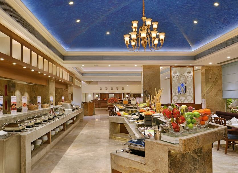 Fortune Landmark, Ahmedabad buffet restaurant with chandelier and blue ceiling