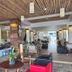 Wild Orchid Villa Krabi lobby with lounge seating, wood ceiling, and colorful decor in Krabi