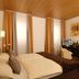 Garni-Hotel Adler, Ostfildern guest room with double bed, desk, and warm wood ceiling