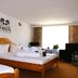 Hotel Restaurant Schwarzes Ross room in Oberwiesenthal with twin wooden beds and a bright window