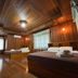 Sri Phairin Resort in Chanthaburi bedroom with two beds, wood-paneled walls and ceiling
