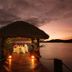Musket Cove Island Resort and Marina overwater dining pavilion at sunset on Malolo Island