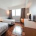 Caritas Oswald Cheung International House room in Hong Kong with two beds, desk and window view