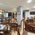 Hotel La Costera in A Lanzada dining room with wooden tables, chairs, and a bar