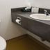 Lake-Vu Motel Kenora bathroom with toilet, sink vanity and wall-mounted toilet paper holder