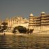 Taj Fateh Prakash Palace Udaipur on Lake Pichola waterfront, with ornate palace facade and domed towers