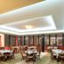 Agriani Hotel in Xánthi dining room with tables, wicker chairs, and large windows
