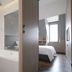 Amrise Hotel Kitchener, Singapore: modern bathroom with bathtub, shower, and bedroom view through open door