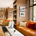 Hotel Eiffel Turenne in Paris lounge with tan sofa, armchair, coffee table, shelving and window light
