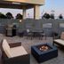 Residence Inn by Marriott Kingston Water's Edge rooftop patio with fire pit, seating, and grill in Kingston