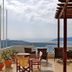 Theoxenia Caldera Hotel in Thera terrace with Greek flag and caldera sea view