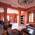La Maison des Oliviers in Marrakech: warm lounge with fireplace, seating, columns and large windows
