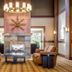 Glacier Lodge in Whistler lobby with stone fireplace, chandelier, and tan armchairs