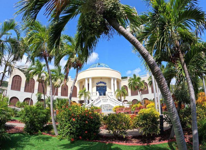 Divi Carina Bay Beach Resort & Casino in Christiansted with palm trees and tropical resort buildings