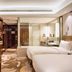 Minyoun Chengdu Dongda Hotel in Chengdu guest room with two beds and glass-walled bathroom