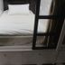 Vintage Inn Boutique Capsule @ Little India Singapore capsule bed with white linens and privacy screen