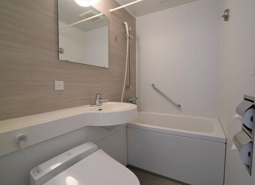 Hotel Katsuyama Premiere bathroom in Matsuyama with bathtub, shower, sink and toilet paper holder
